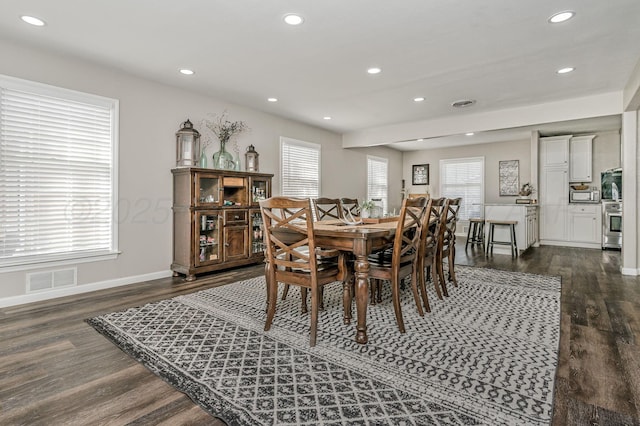 dining space with recessed lighting, plenty of natural light, and dark wood-style floors