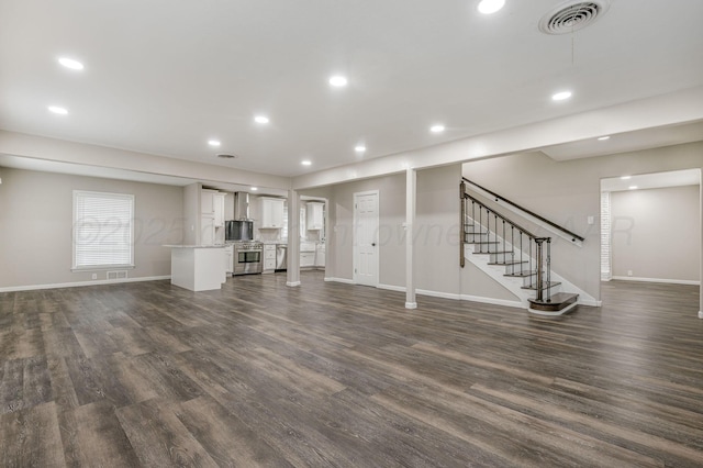 2421 Duncan St, Pampa, TX 79065 - unfurnished living room featuring baseboards, dark wood finished floors, recessed lighting, and stairs