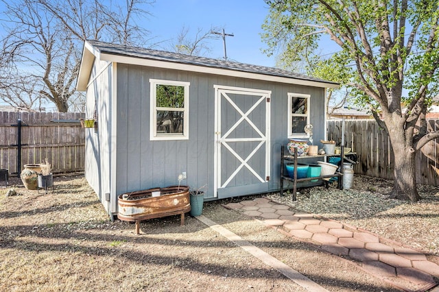 view of shed with a fenced backyard