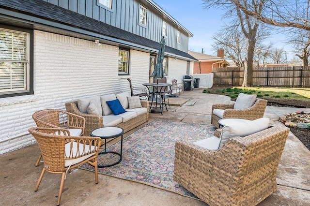 view of patio with outdoor lounge area, grilling area, and fence