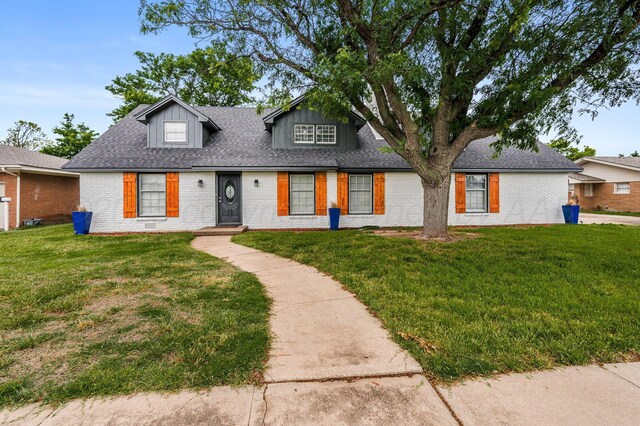 2421 Duncan St, Pampa, TX 79065 - view of front of home featuring brick siding, a front yard, and a shingled roof