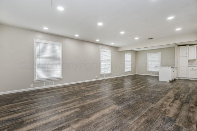 2421 Duncan St, Pampa, TX 79065 - unfurnished living room featuring dark wood-type flooring, recessed lighting, and baseboards