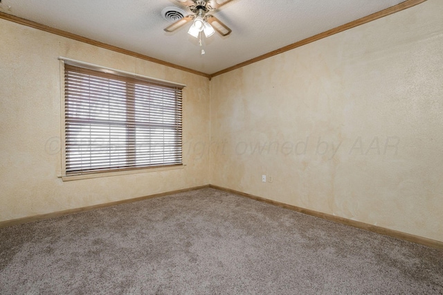 spare room featuring ceiling fan, carpet, ornamental molding, and a textured ceiling