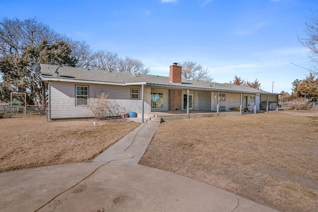 view of front of property with a front yard and a patio area