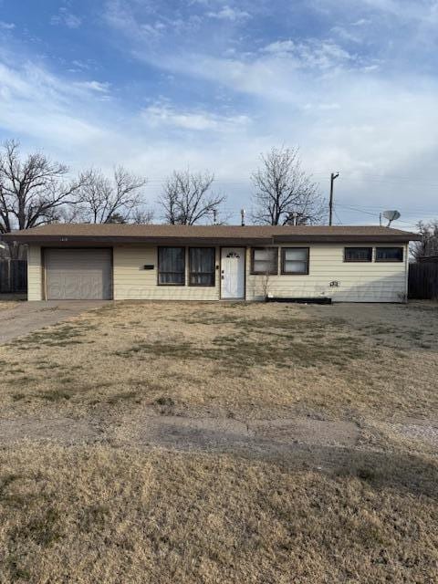 view of front of property featuring a garage and fence