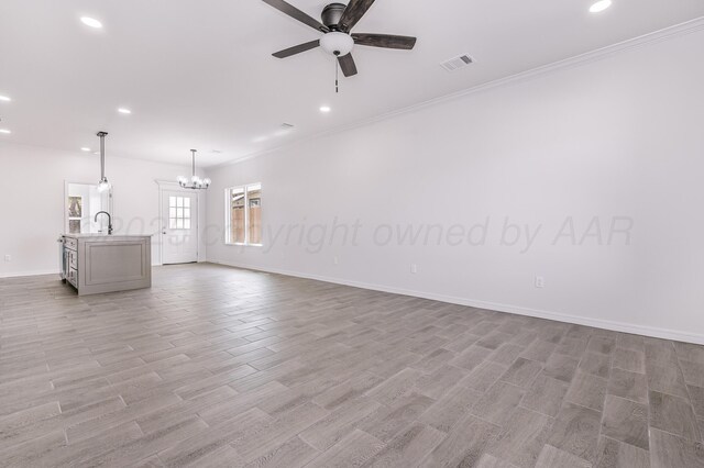 307 S Tennessee St, Amarillo, TX 79106 - unfurnished living room with crown molding, recessed lighting, visible vents, and ceiling fan with notable chandelier