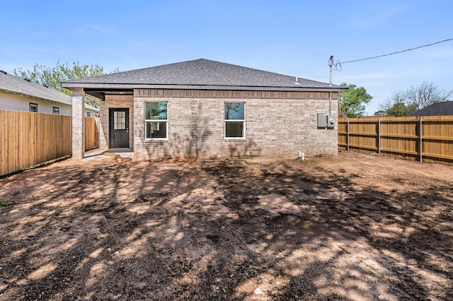 307 S Tennessee St, Amarillo, TX 79106 - back of house with brick siding, a fenced backyard, and a shingled roof