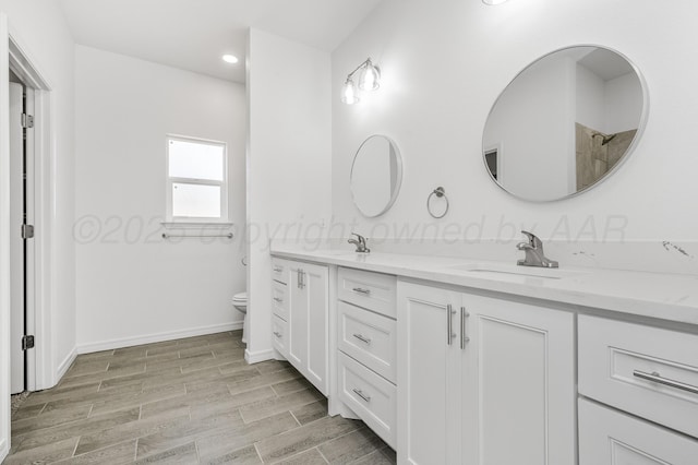 307 S Tennessee St, Amarillo, TX 79106 - bathroom featuring double vanity, wood finished floors, a sink, toilet, and recessed lighting