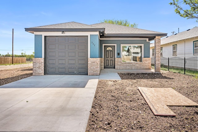 307 S Tennessee St, Amarillo, TX 79106 - view of front of home featuring fence, an attached garage, concrete driveway, and stucco siding