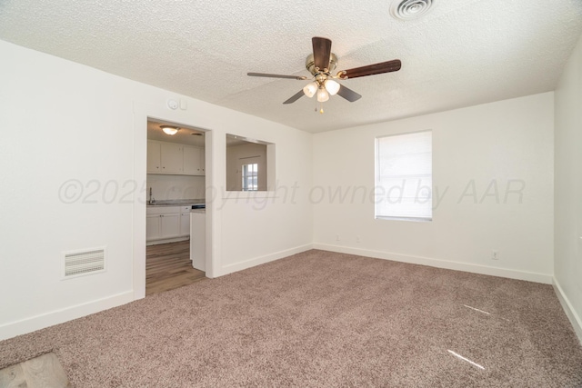 4106 S Jackson St, Amarillo, TX 79110 - spare room featuring light carpet, ceiling fan, and a textured ceiling