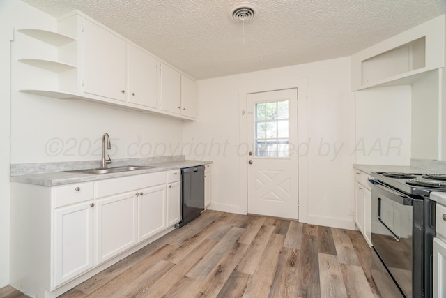4106 S Jackson St, Amarillo, TX 79110 - kitchen featuring black appliances, open shelves, light wood finished floors, a textured ceiling, and light countertops