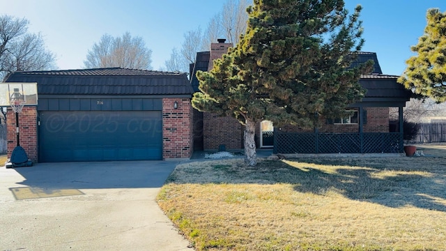 view of front of home with driveway, a garage, brick siding, a tile roof, and a front yard