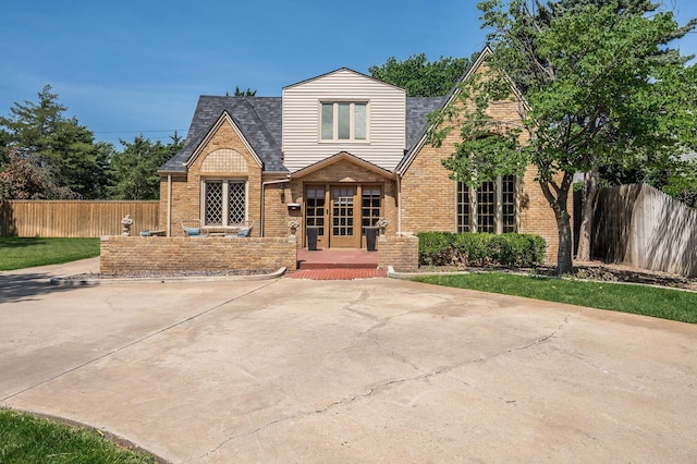 tudor home featuring french doors