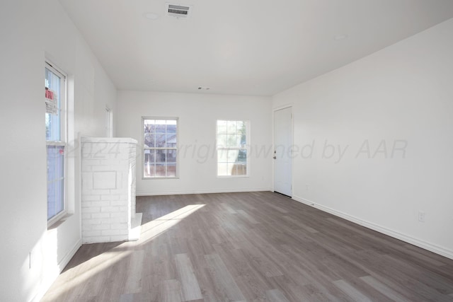 spare room featuring wood finished floors and baseboards