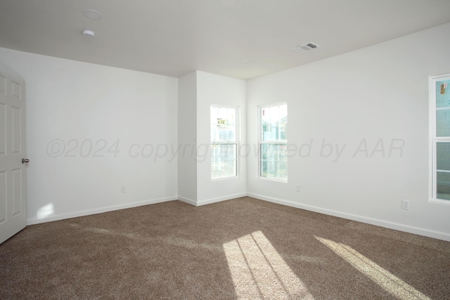 carpeted empty room with baseboards