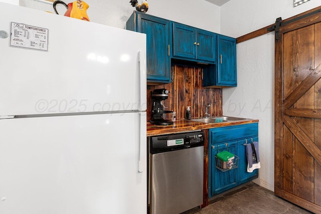 5207 Echo St, Amarillo, TX 79108 - kitchen with freestanding refrigerator, stainless steel dishwasher, blue cabinetry, and a barn door