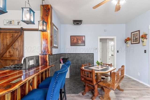 5207 Echo St, Amarillo, TX 79108 - dining room featuring a ceiling fan, wood finished floors, and tile walls