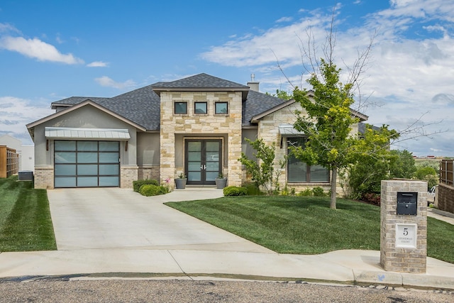 view of front of house with a garage and a front lawn