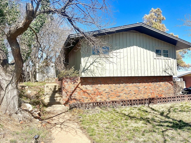 view of property exterior with brick siding