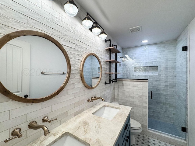 6501 Glenwood Dr, Amarillo, TX 79119 - bathroom with visible vents, a sink, a shower stall, and toilet