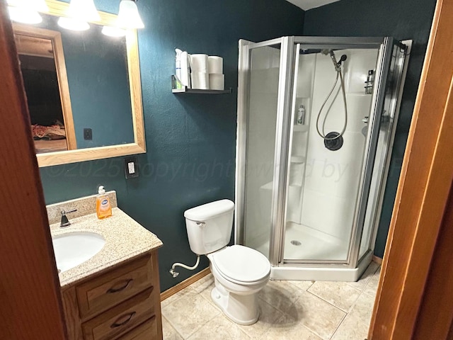 bathroom featuring vanity, tile patterned floors, toilet, and walk in shower