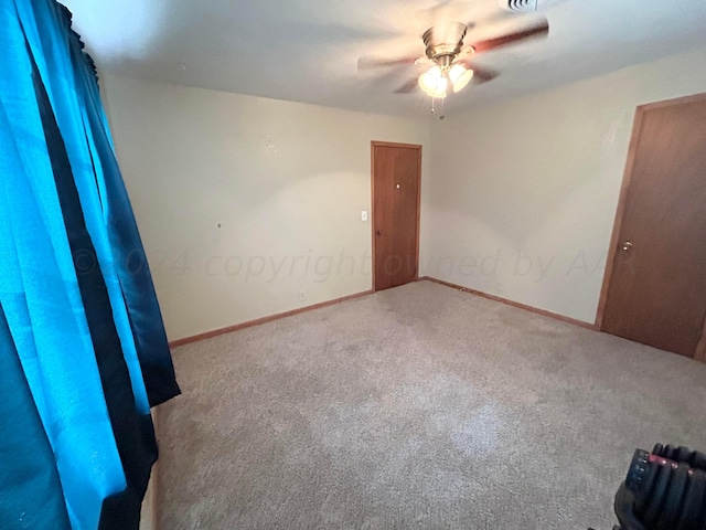 spare room with carpet flooring and ceiling fan