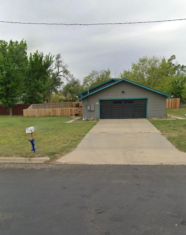 view of front facade featuring a garage and a front lawn