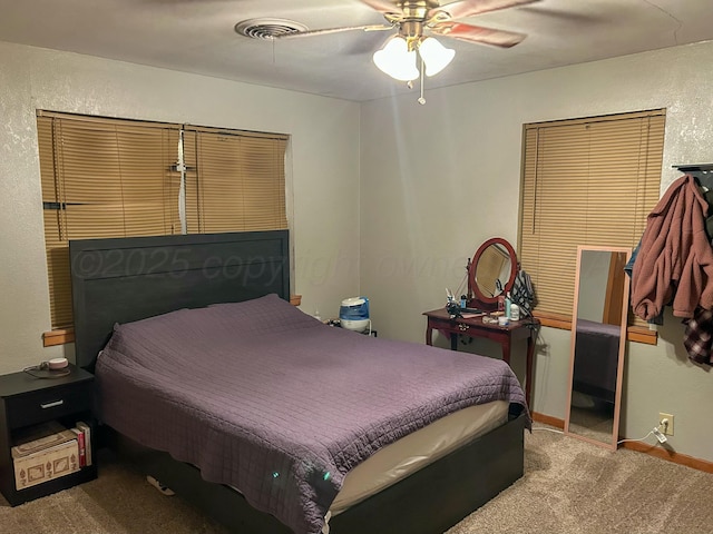 bedroom with ceiling fan and light colored carpet