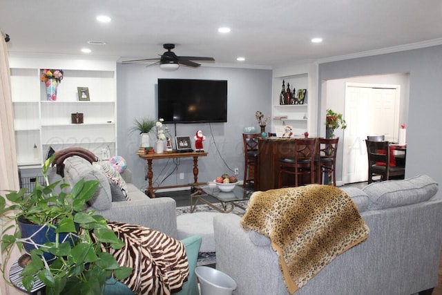 living room with ornamental molding, a dry bar, a ceiling fan, and recessed lighting