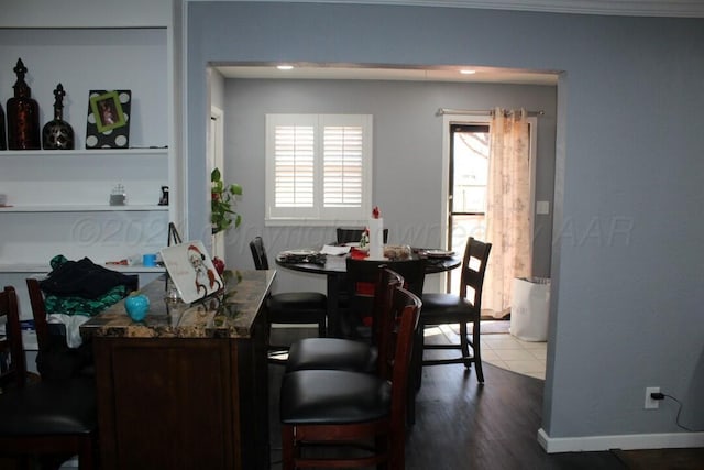 dining room with baseboards and wood finished floors