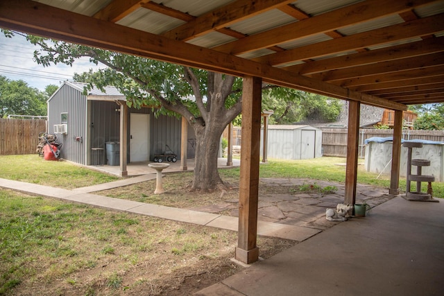503 Maple Ave, Panhandle, TX 79068 - fenced backyard with a storage unit and a patio