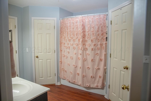 503 Maple Ave, Panhandle, TX 79068 - full bathroom with wood finished floors, vanity, and shower / bath combination with curtain