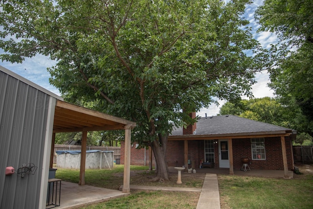 503 Maple Ave, Panhandle, TX 79068 - back of house with a patio area, a chimney, and brick siding