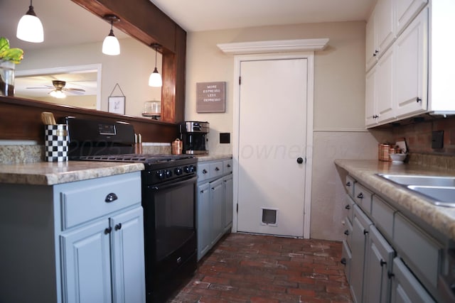 3603 S Lamar St, Amarillo, TX 79109 - kitchen featuring black range with gas stovetop, ceiling fan, brick floors, light countertops, and decorative light fixtures