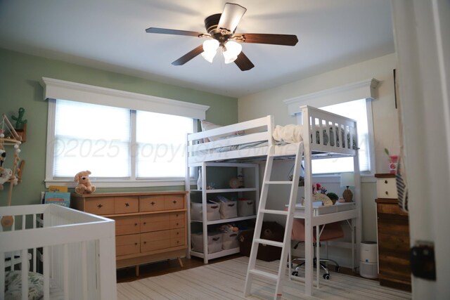 3603 S Lamar St, Amarillo, TX 79109 - bedroom featuring wood finished floors, a ceiling fan, and a crib