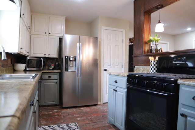3603 S Lamar St, Amarillo, TX 79109 - kitchen featuring appliances with stainless steel finishes, brick flooring, white cabinetry, light countertops, and tasteful backsplash
