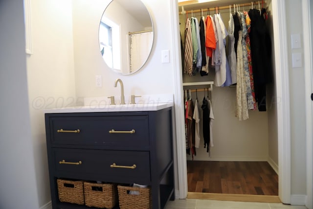 3603 S Lamar St, Amarillo, TX 79109 - full bathroom with vanity, wood finished floors, and a walk in closet