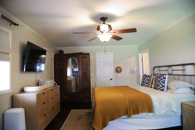 3603 S Lamar St, Amarillo, TX 79109 - bedroom with crown molding, a ceiling fan, and dark wood-style flooring