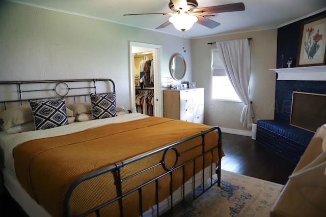 3603 S Lamar St, Amarillo, TX 79109 - bedroom with wood finished floors, a spacious closet, a fireplace, a ceiling fan, and ornamental molding
