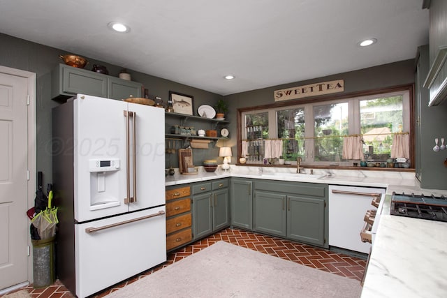 907 Broadmoor St, Amarillo, TX 79106 - kitchen with white appliances, brick patterned floors, recessed lighting, open shelves, and light stone countertops