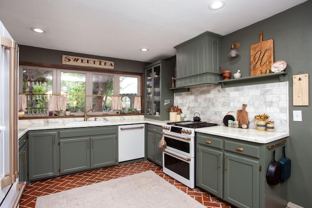 907 Broadmoor St, Amarillo, TX 79106 - kitchen with white appliances, backsplash, brick floors, recessed lighting, and custom range hood