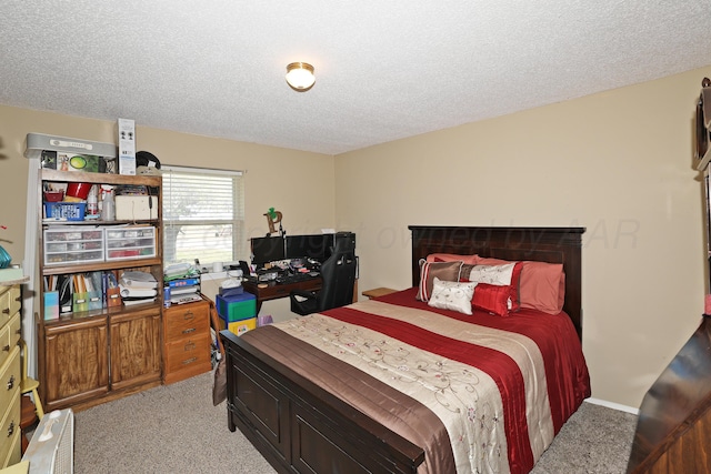 carpeted bedroom featuring a textured ceiling