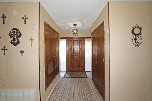 entryway with a textured ceiling