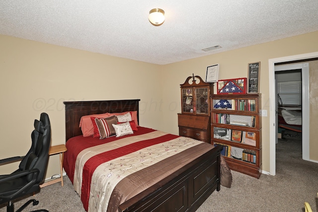 carpeted bedroom with a textured ceiling