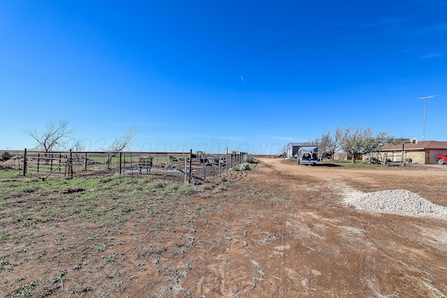 view of yard with a rural view