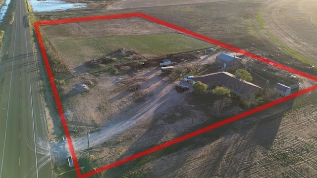 birds eye view of property with a rural view