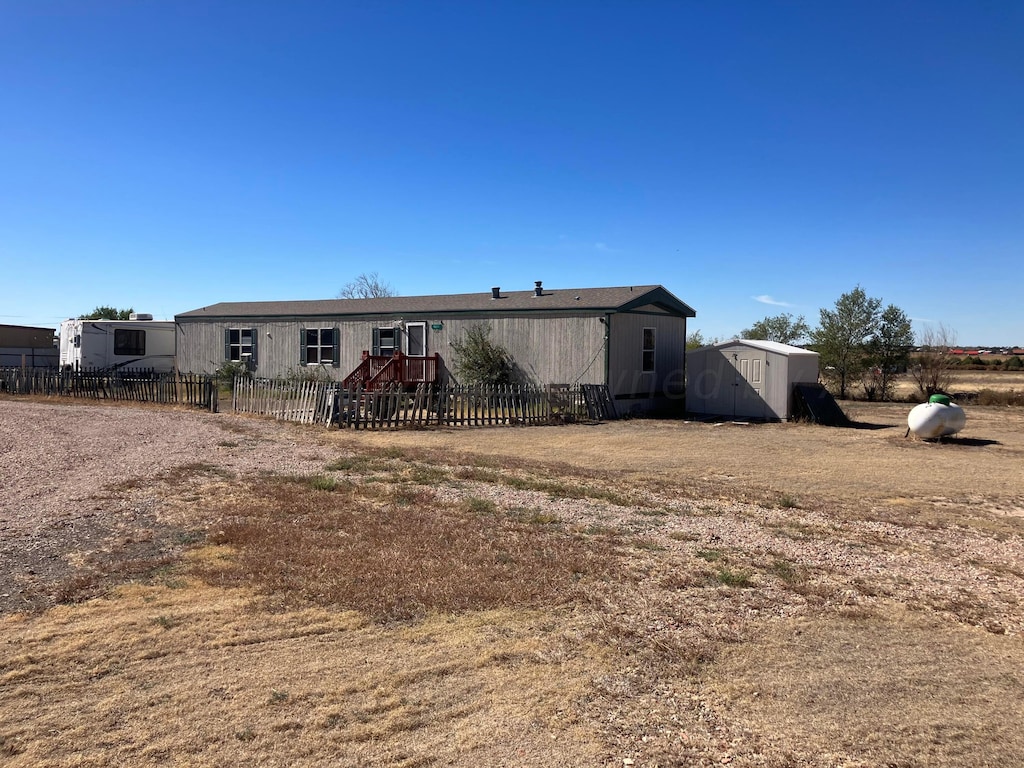 view of front of house with a storage shed