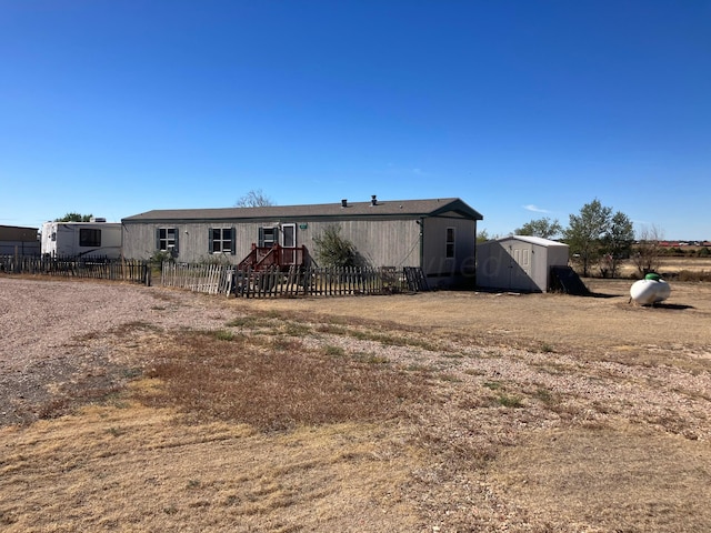 view of front of house with a storage shed