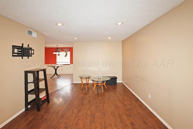 dining room featuring dark hardwood / wood-style flooring and a textured ceiling