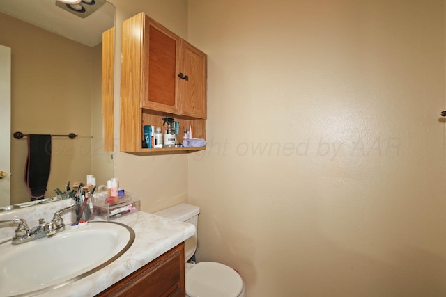 bathroom featuring toilet and vanity